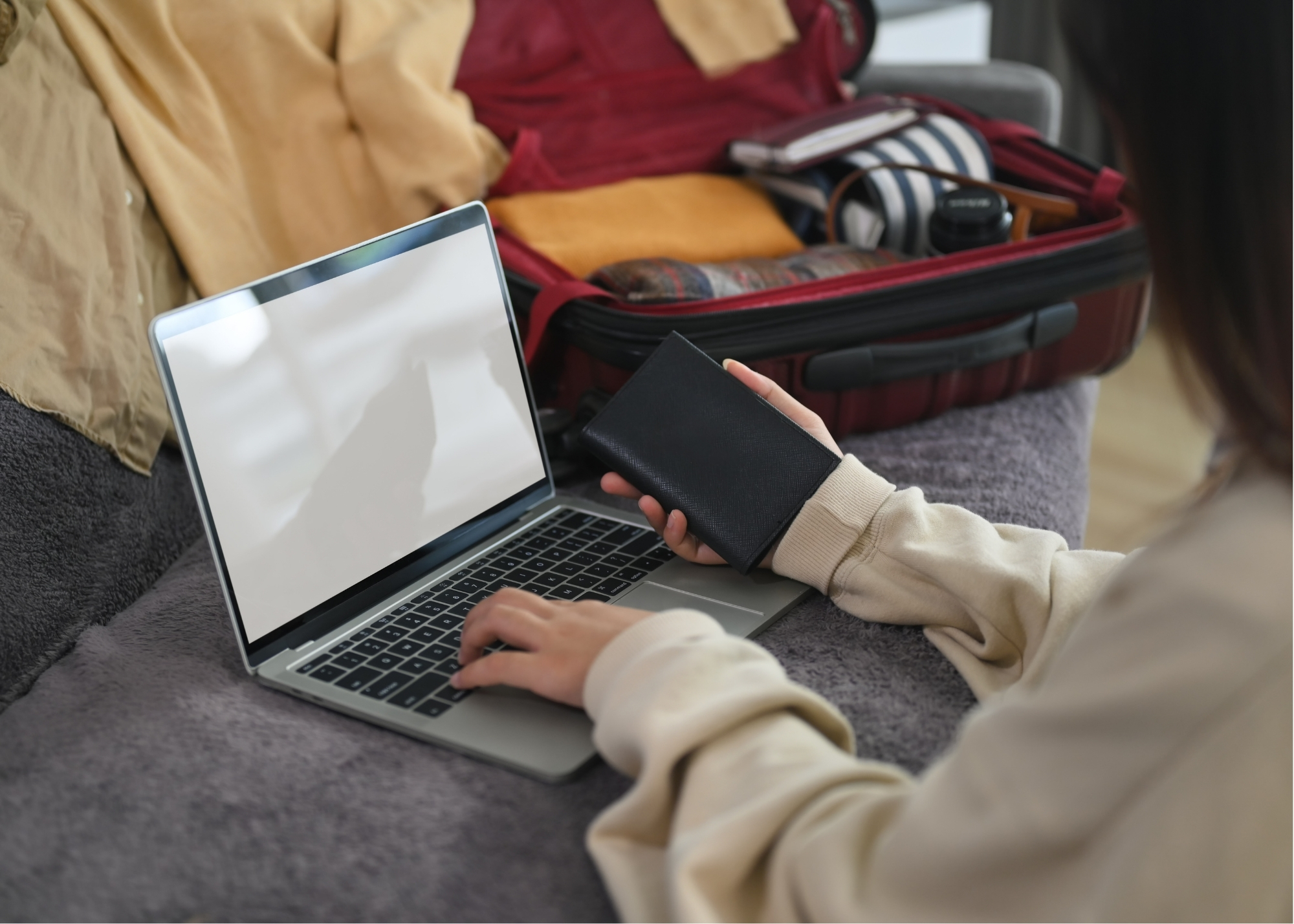 A traveler reviewing information on a laptop before visiting a new place.